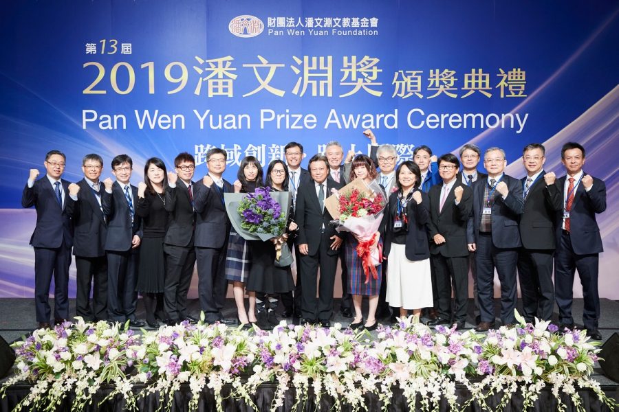 Hermes-Epitek employees present bouquets to Chairman Archie Hwang (front row center).